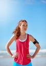 Runner woman, beach and sky with earphones for music, workout motivation and training by ocean. Athlete girl, exercise Royalty Free Stock Photo