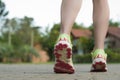 Runner woman feet running on road closeup on shoe. Female fitness athlete jogger workout in wellness concept at sunrise. Sports Royalty Free Stock Photo