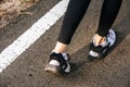 Runner woman feet running on road closeup on shoe. Sports healthy lifestyle concept Royalty Free Stock Photo