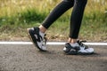 Runner woman feet running on road closeup on shoe. Sports healthy lifestyle concept Royalty Free Stock Photo