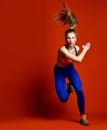 Runner woman isolated. Running fit fitness sport model jogging isolated on red background.