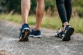 Runner woman and man feet running on road closeup on shoe. Sports healthy lifestyle concept Royalty Free Stock Photo