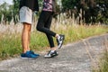 Runner woman and man feet running on road closeup on shoe. Sports healthy lifestyle concept Royalty Free Stock Photo