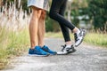 Runner woman and man feet running on road closeup on shoe. Sports healthy lifestyle concept Royalty Free Stock Photo