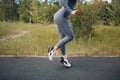 Runner woman in running shoes closeup of woman sporty legs. Female jogging.