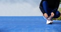 Runner woman tying up laces of shoes, getting ready to run for cardio and weight loss Royalty Free Stock Photo