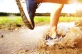 Runner's sneakers splashing in mud puddle Royalty Free Stock Photo