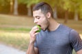 Runner young latin man eating apple running jogging sports training fitness copyspace copy space Royalty Free Stock Photo