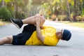 Runners catch the knee from accident on road in public park. Injury from run. Royalty Free Stock Photo