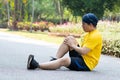 Runners catch the knee from accident on road in public park. Injury from run. Royalty Free Stock Photo