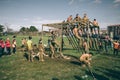 Runners climbing structure in a test of extreme obstacle race