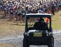 Runners following cart at the start of a girls cross country race