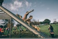 Runners going down structure in a test of extreme obstacle race