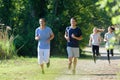 runners jogging outdoors through forest trail Royalty Free Stock Photo
