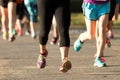 Runners legs at a 5K on a dirt psth