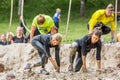 Runners in a mud obstacle. Royalty Free Stock Photo