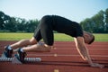 Runners preparing for race at starting blocks Royalty Free Stock Photo