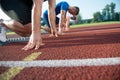 Runners preparing for race at starting blocks Royalty Free Stock Photo