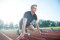 Runners preparing for race at starting blocks Royalty Free Stock Photo