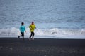 Runners running at black beach in iceland