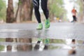 Runners running in city marathon, motion blur on sporty legs