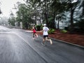 Runners Running on a Wet Road - Long Exposure