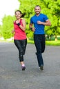 Runners training outdoors working out. City running couple jogging outside.