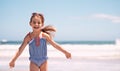 Running with absolute abandon. a little girl running along the beach. Royalty Free Stock Photo