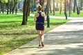 Running. Active woman runs cross in the summer park.