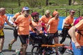 Running Angels carrying a man in wheelchair in the Rome Marathon race of 2019