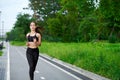 Running asian woman on running track. Morning jogging. The athlete training