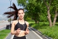 Running asian woman on running track. Morning jogging. The athlete training