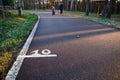 Running asphalt track in the forest with a mark of 10 meters. Royalty Free Stock Photo