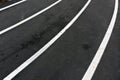 Running asphalt track with white painted lines. Royalty Free Stock Photo