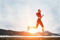 Running athlete on the background of snowy mountains Royalty Free Stock Photo