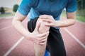 Running athlete feeling pain because of injured knee