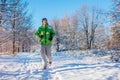 Running athlete man sprinting in winter forest. Training outside in cold snowy weather. Active healthy way of life Royalty Free Stock Photo