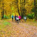 Running athletes in the park on a run in the early morning. Several children are running in the woods doing sports Royalty Free Stock Photo