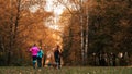 Running athletes in the park on a run in the early morning. Several children are running in the woods doing sports Royalty Free Stock Photo