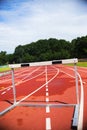 Running athletic track with hurdle, bad weather, wet Royalty Free Stock Photo