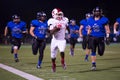 Friday Night Lights High School Football Running back outrunning defensive team Royalty Free Stock Photo