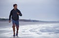 Running, beach and man with vacation, health and exercise with nature, energy and ocean. Person, runner and guy with fun Royalty Free Stock Photo