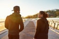 Running on the bridge at sunrise. African couple talking before morning jog outdoors. Female and male adult african