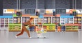 Running business man customer with shopping trolley cart busy male shopper buying products grocery market interior flat