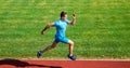 Running challenge for beginners. Athlete run track grass background. Sprinter training at stadium track. Runner captured