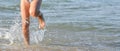 Running child girl legs on the beach and copy space Royalty Free Stock Photo