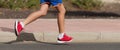 Running child, young athlete run in a kid run race, running on city road detail on legs Royalty Free Stock Photo