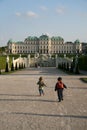 Running children in Belvedere Palace Gardens in Vienna, Austria