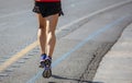 Running in the city roads. Young man runner, back view, blur background, copy space Royalty Free Stock Photo