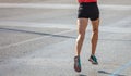 Running in the city roads. Young man runner, back view, blur background, copy space Royalty Free Stock Photo